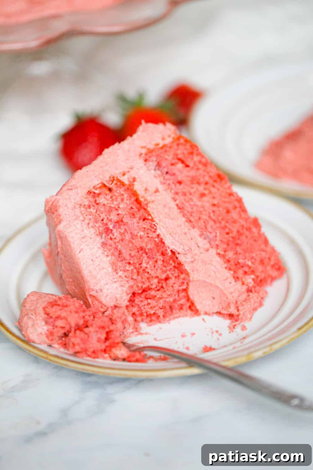 Strawberry Serenade 6 strawberry cake recipe - frosted cake with a slice removed