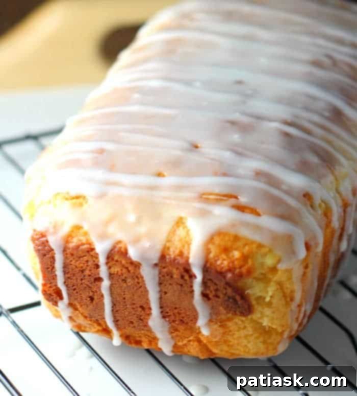 25 Heavenly Summer Desserts 28 Slice of Lemon Limoncello Cake Loaf, showcasing the moist texture and glaze.