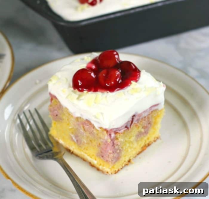 25 Heavenly Summer Desserts 9 Very Cherry Cheesecake Poke Cake, with visible cherry filling and a creamy topping.