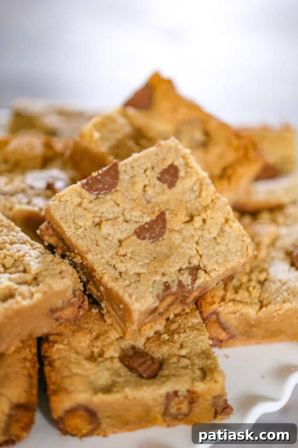 Irresistible Peanut Butter Cup Blondies 3 Close-up of baked blondies with visible peanut butter cups, ready for slicing