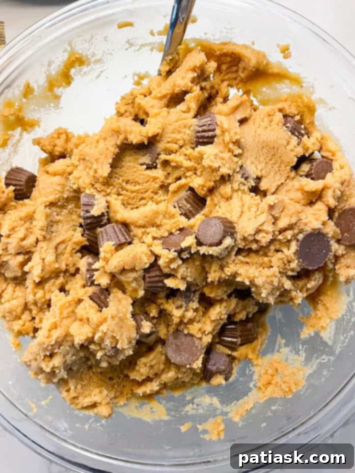 Irresistible Peanut Butter Cup Blondies 4 Blondie batter with generous amounts of Reese's peanut butter cups folded in