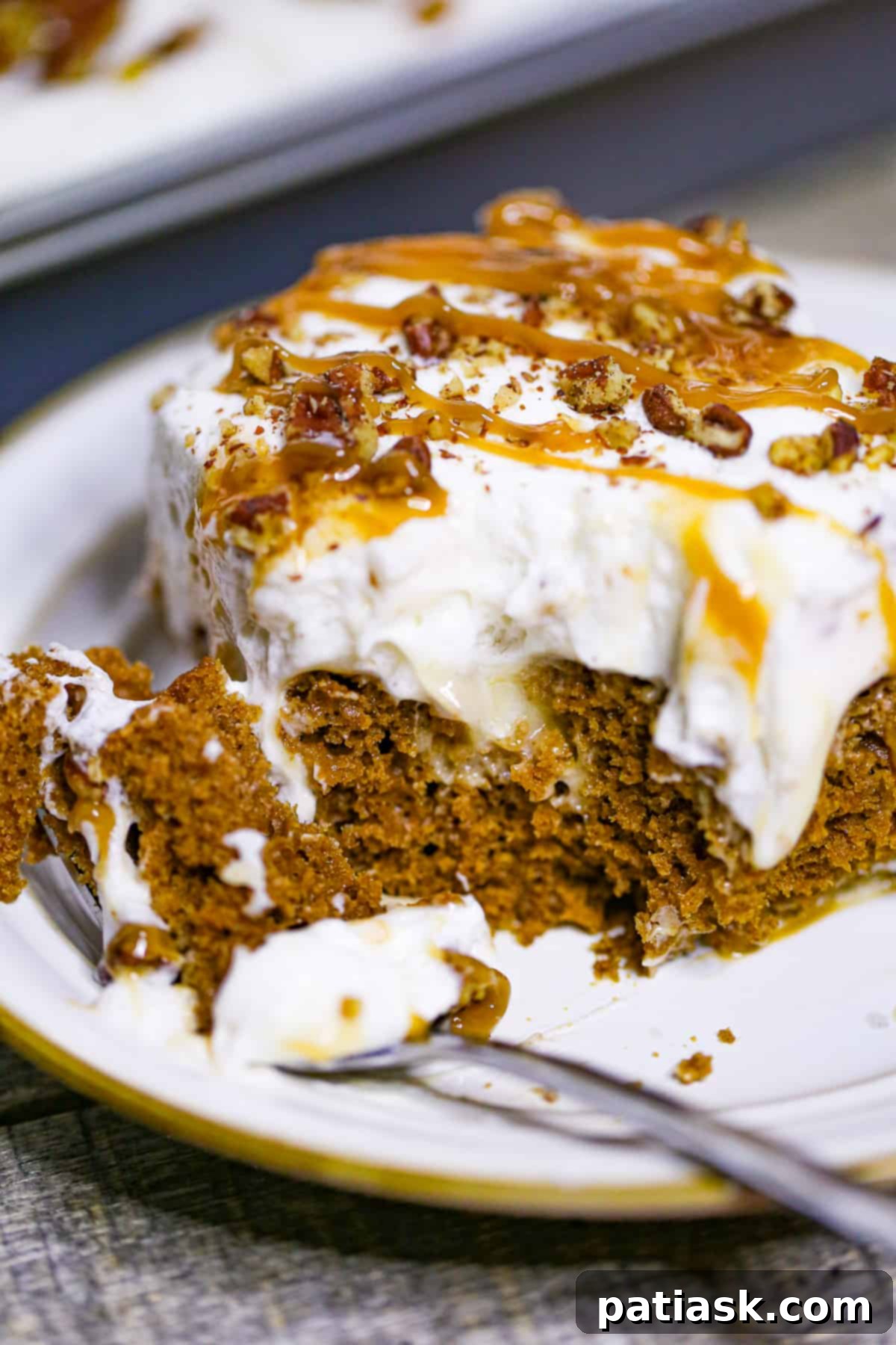 Carrot Cake Delight with Creamy Pockets 3 Carrot Cake Poke Cake with spoon showing creamy layers