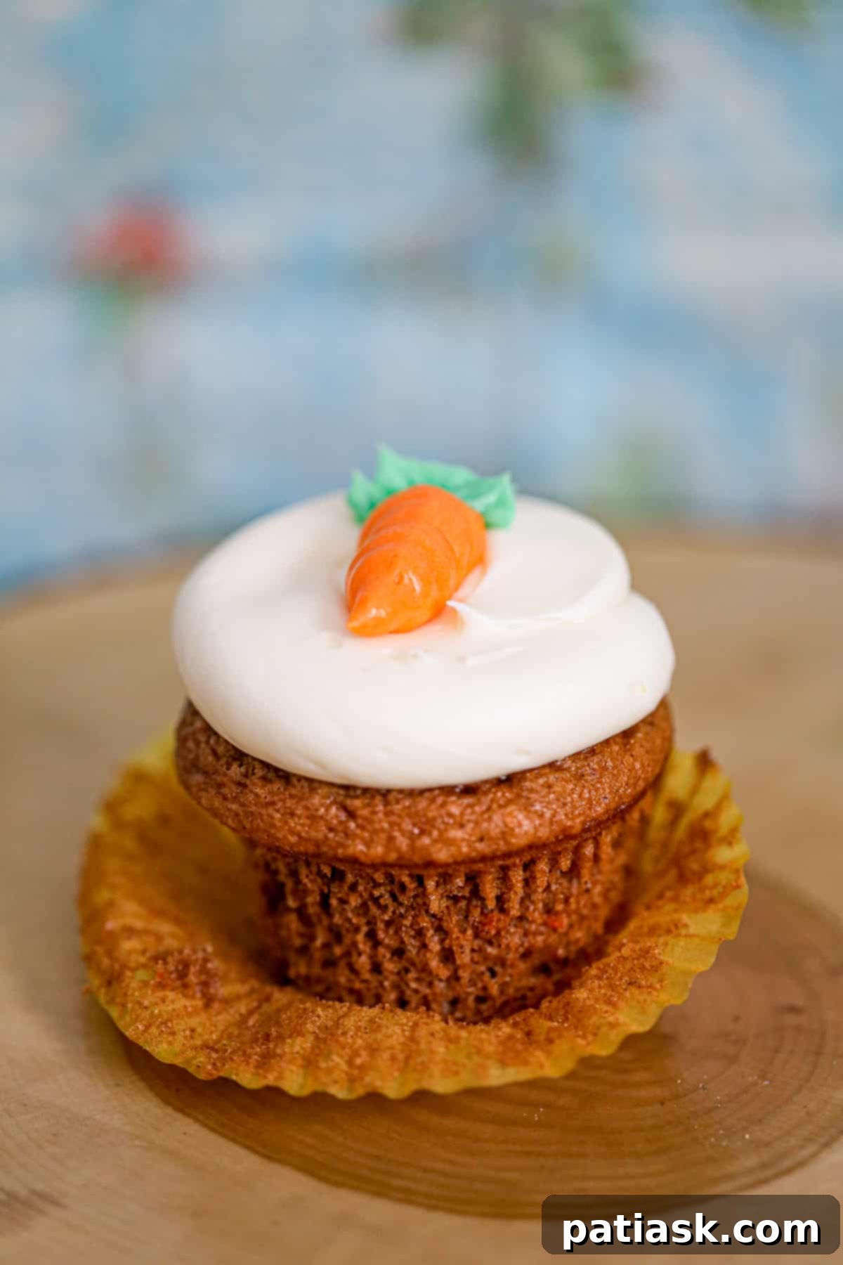 Carrot cake cupcake with traditional cream cheese frosting, ready for sharing