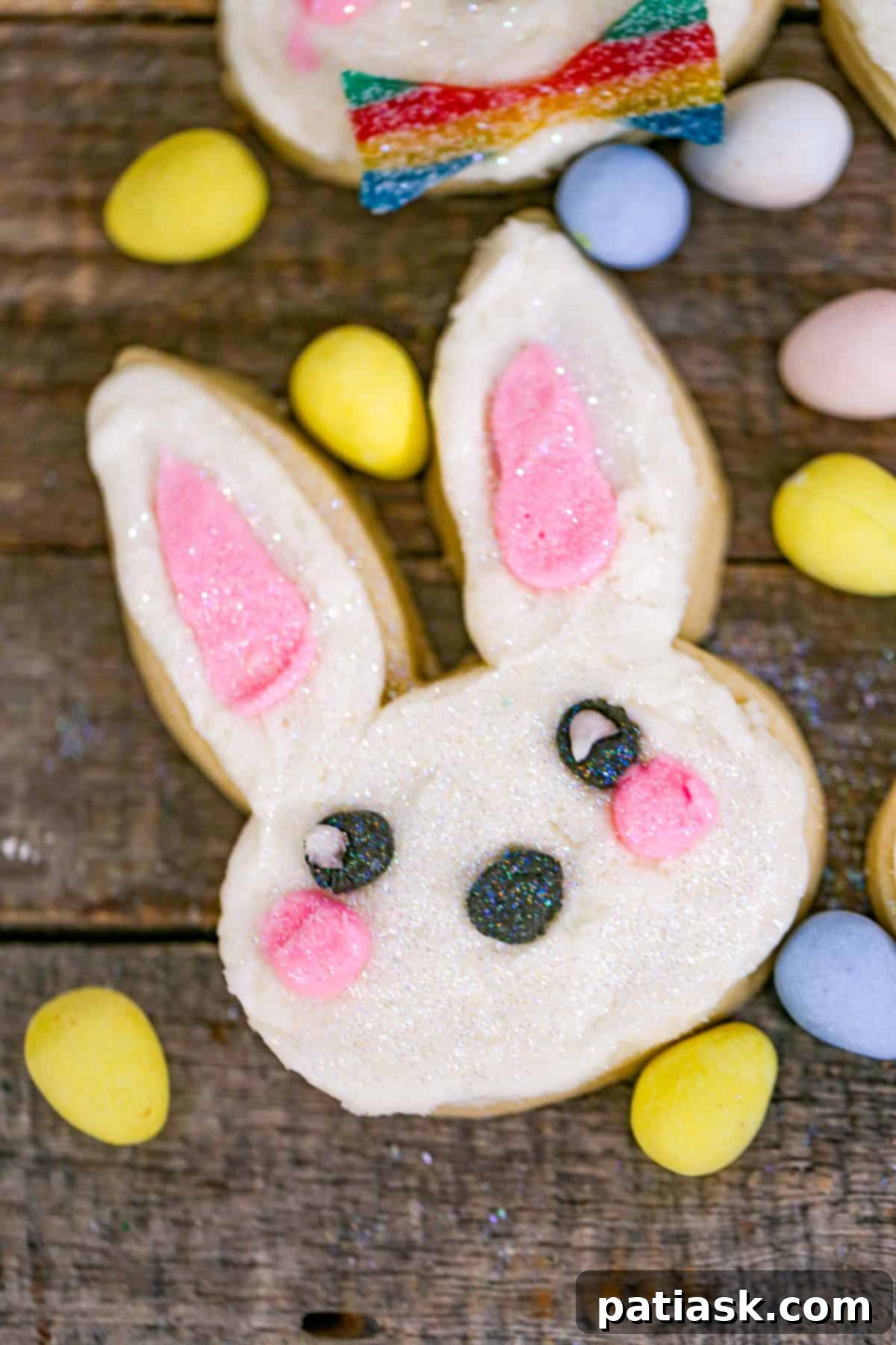 Whimsical Easter Bunny Cookies 4 An array of beautifully decorated Easter Bunny Sugar Cookies on a rustic wooden board.