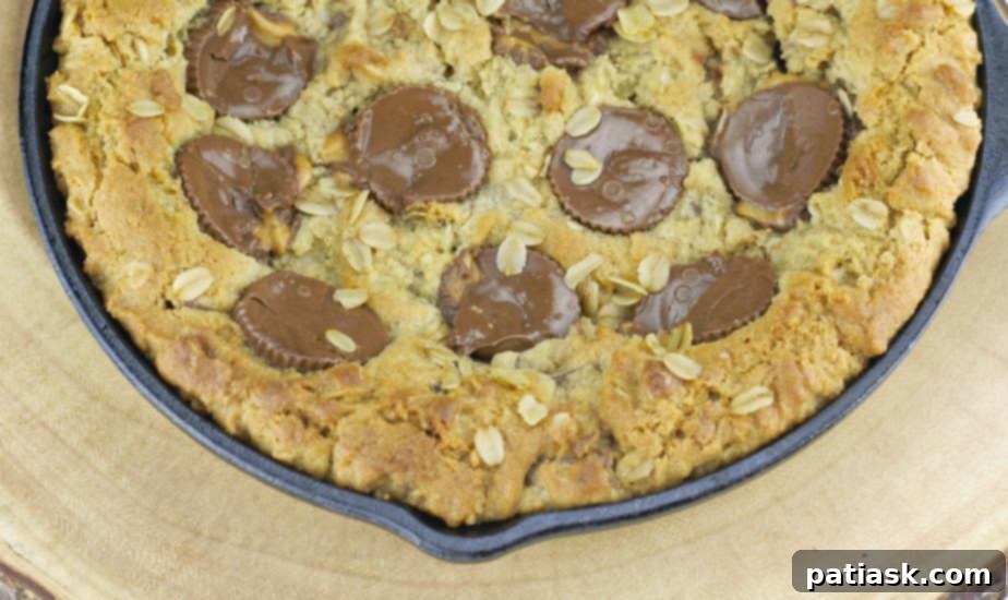 Decadent Peanut Butter Cup Skillet Cookie 5 Peanut Butter Cup Oatmeal Chocolate Chip Skillet Cookie with melting ice cream