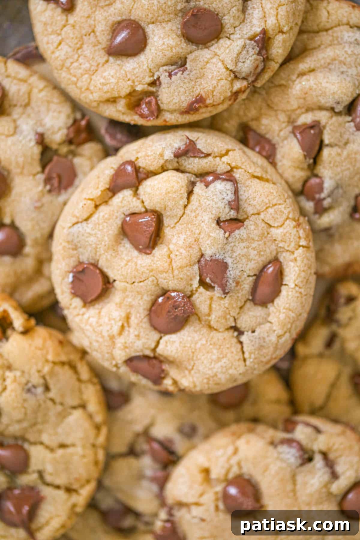 Perfect Crumbl-Inspired Chocolate Chip Cookies 7 Overhead view of a single CopyCat Crumbl Chocolate Chip Cookie, perfectly round with a beautiful texture and plenty of chocolate.