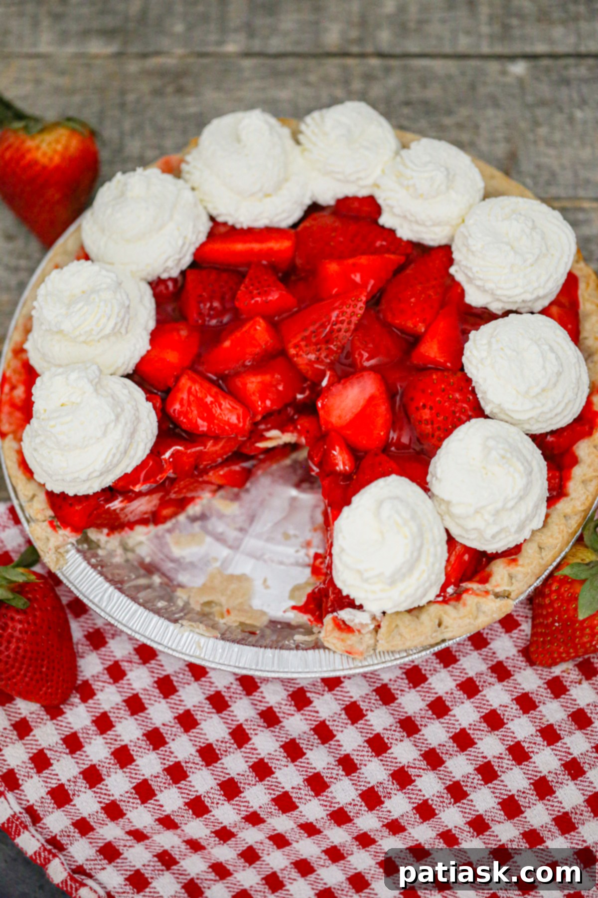 The Authentic Shoney's Strawberry Pie Copycat 3 Close-up of a fresh strawberry pie with a golden crust and glistening strawberry topping, viewed from above.