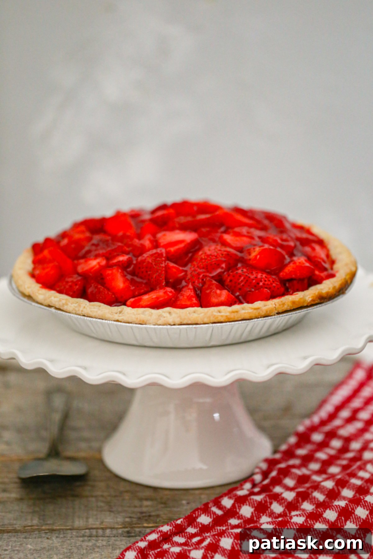 The Authentic Shoney's Strawberry Pie Copycat 6 Two slices of Classic Copycat Shoney’s Strawberry Pie served on white plates, garnished with whipped cream and fresh mint.