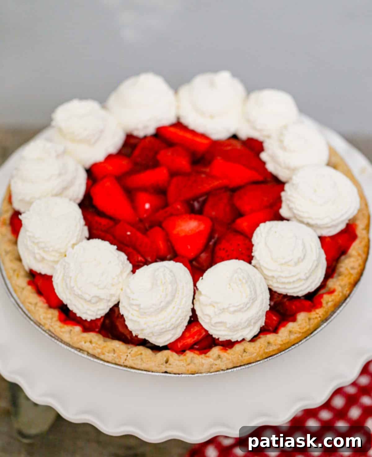 The Authentic Shoney's Strawberry Pie Copycat 7 A whole original fresh strawberry pie on a wooden stand, showcasing its vibrant color and abundant berries.