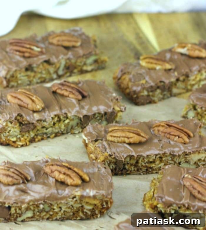 Decadent Caramel Pecan Chocolate Oat Squares 5 Close-up of a cut Caramel Pecan Chocolate Oat Cookie Bar, showing layers of chocolate, caramel, and pecans