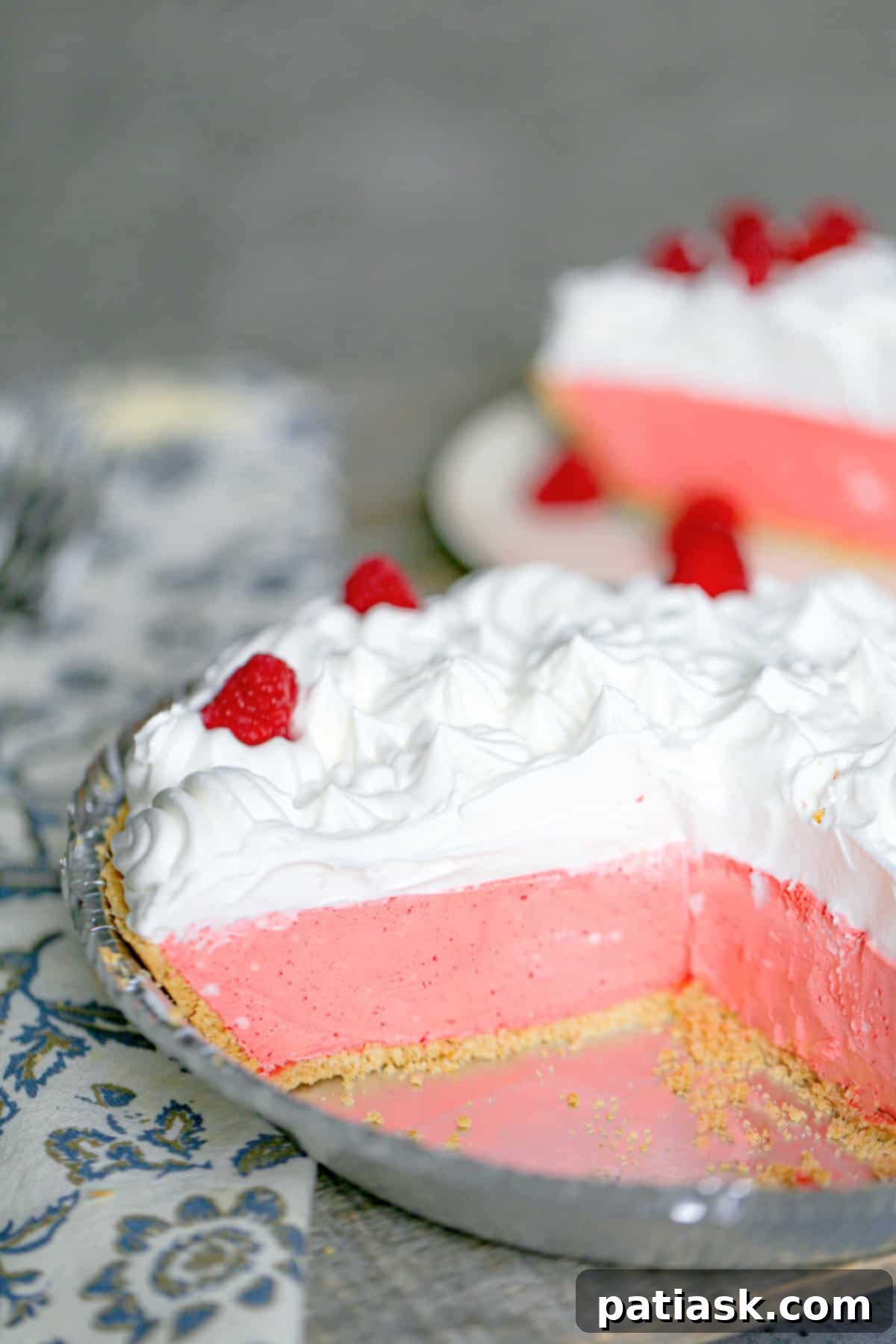 Easy 3 Ingredient Jello Cool Whip Pie 9 A slice of Jello Cool Whip Pie garnished with fresh berries