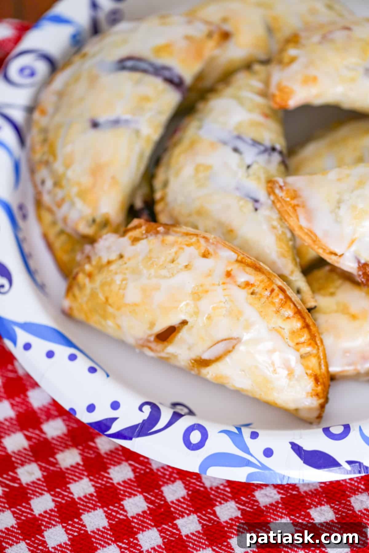 Sweet Fruit Pockets 2 easy hand held pies recipe with shortcuts apple, blueberry, cherry, peach, blueberry, raspberry fillings using pie crust and topped with glaze