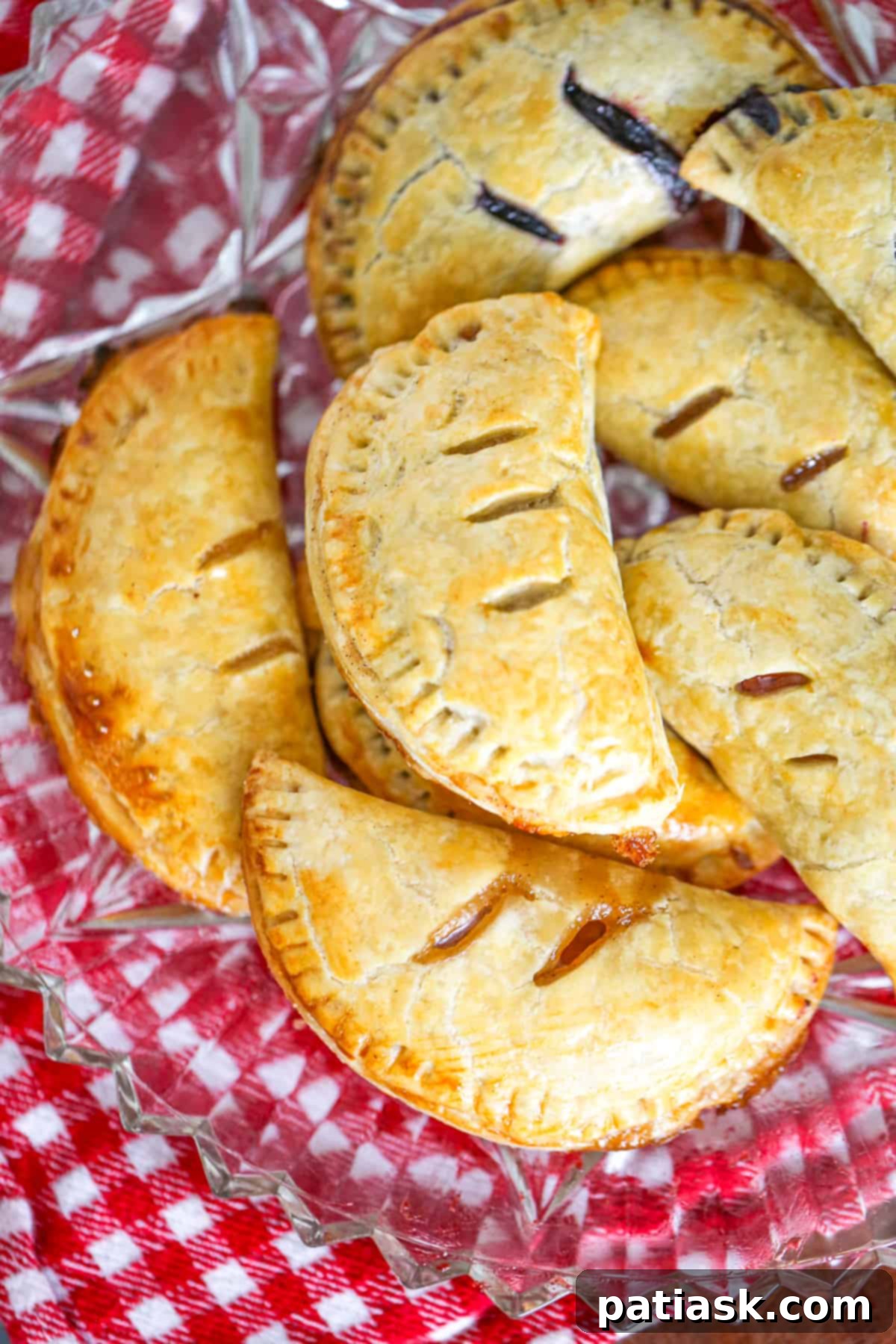 Sweet Fruit Pockets 3 easy hand held pies recipe with shortcuts apple, blueberry, cherry, peach, blueberry, raspberry fillings using pie crust and topped with glaze