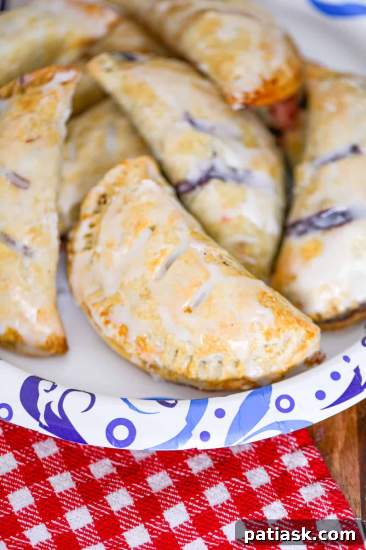 Sweet Fruit Pockets 9 easy hand held pies recipe with shortcuts apple, blueberry, cherry, peach, blueberry, raspberry fillings using pie crust and topped with glaze