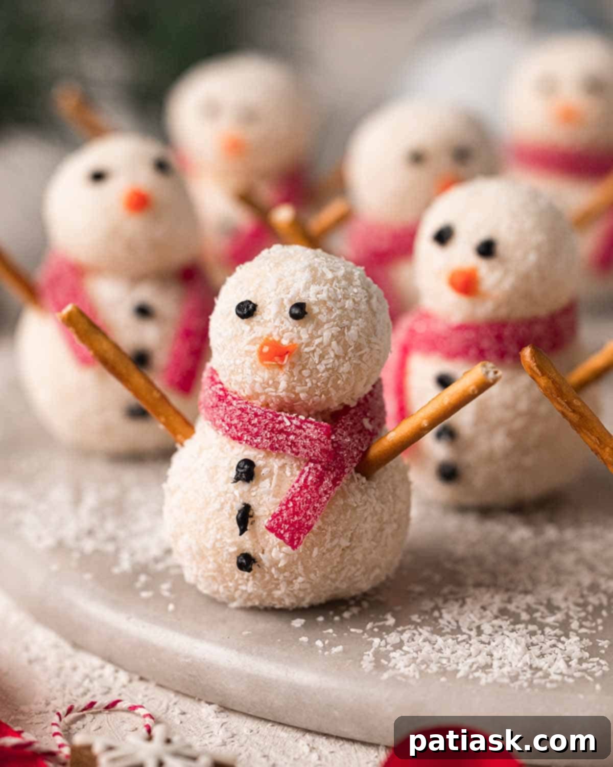 Adorable Coconut Snowmen made from 2-ingredient truffles, decorated for Christmas
