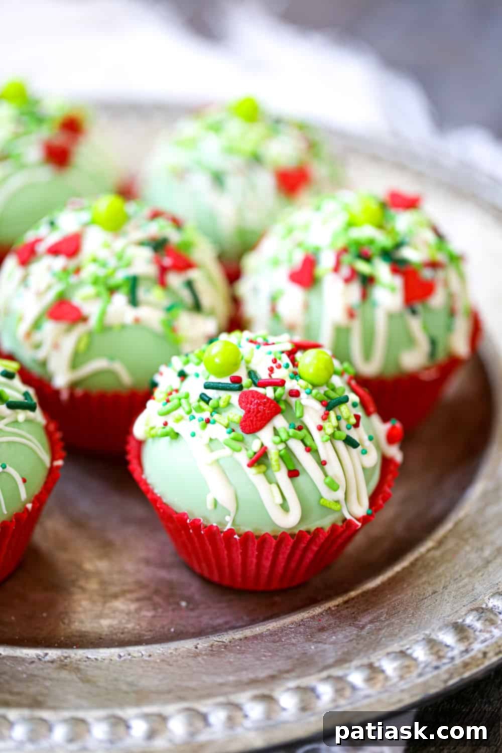 Festive Grinch Cocoa Bombs, perfect for a warm holiday drink