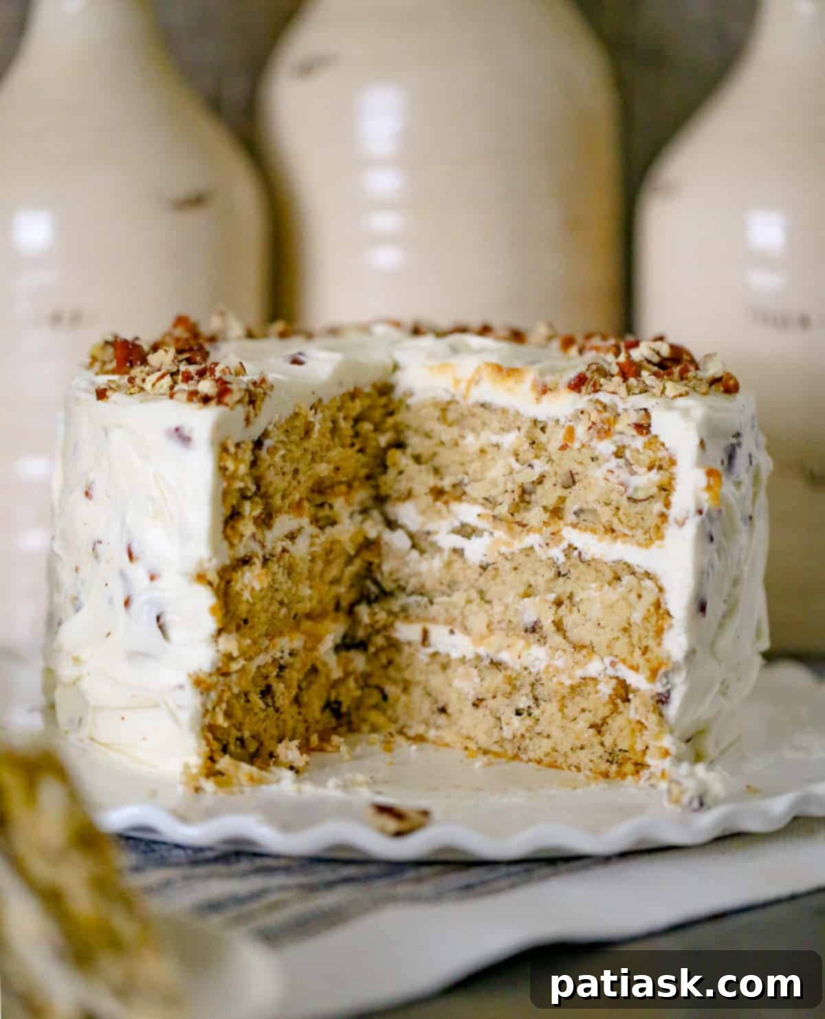 Whole Italian Cream Cake on a cake stand, ready for slicing.