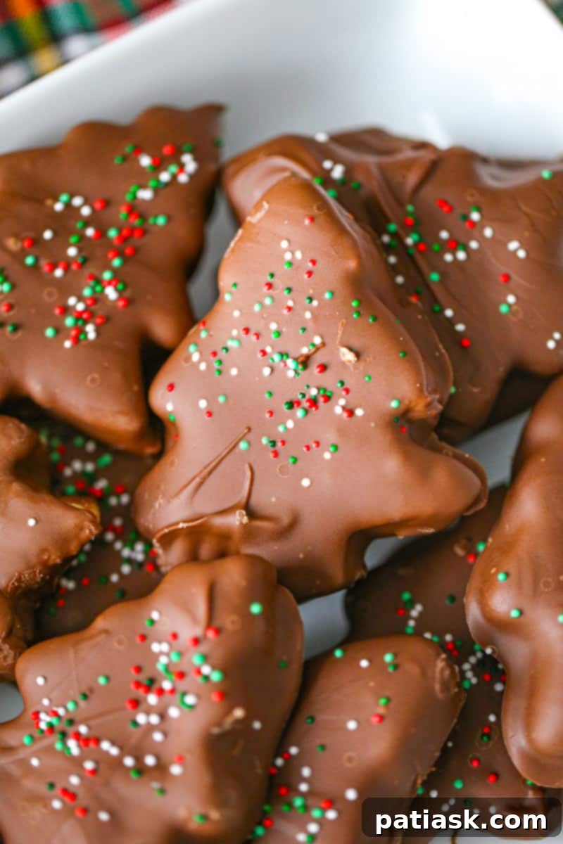 Festive Peanut Butter Chocolate Trees 4 Peanut Butter Christmas Trees covered in chocolate and decorated with sprinkles