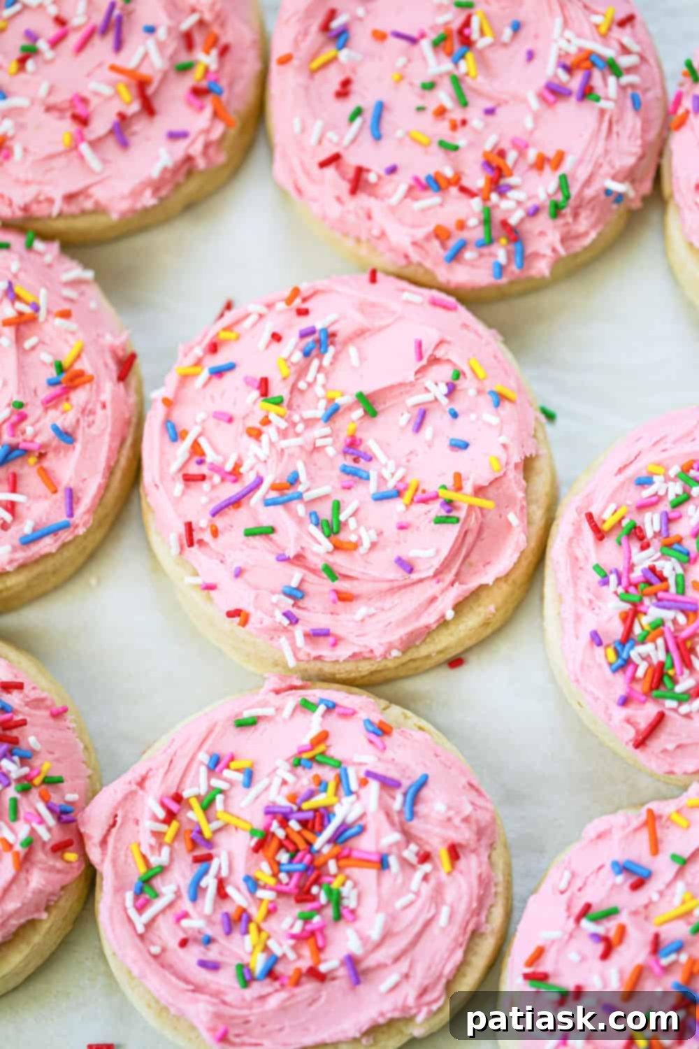 65 Festive Christmas Cookie Creations 44 Soft Lofthouse Cookies with pink frosting and rainbow sprinkles