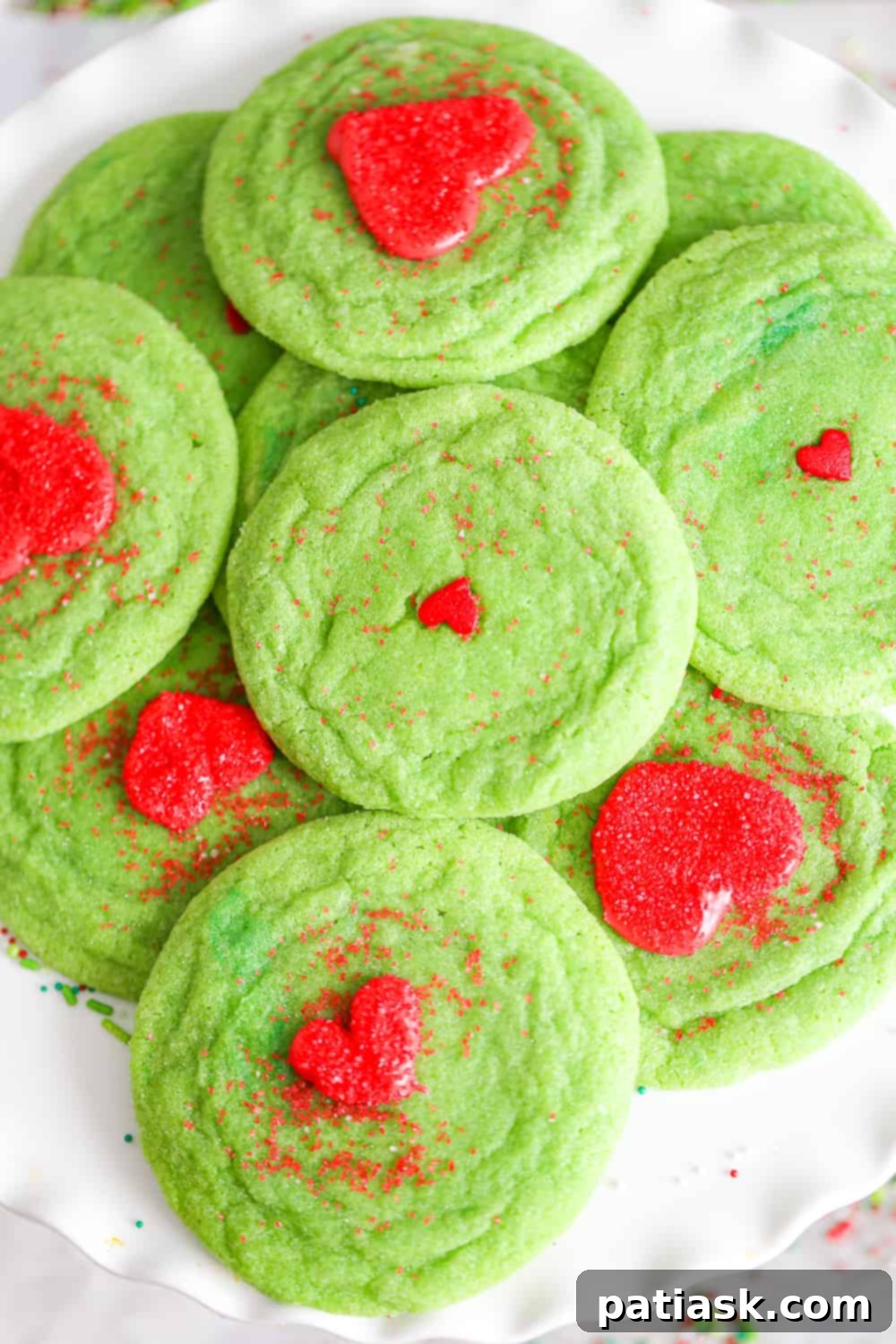 65 Festive Christmas Cookie Creations 6 Playful Grinch Sugar Cookies with green frosting and red hearts