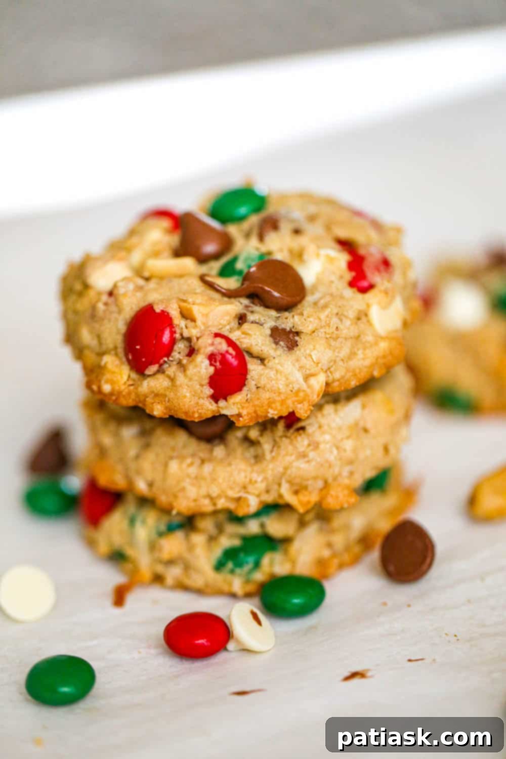 65 Festive Christmas Cookie Creations 52 Stack of Christmas Cowboy Cookies with visible oats, nuts, and M&M's