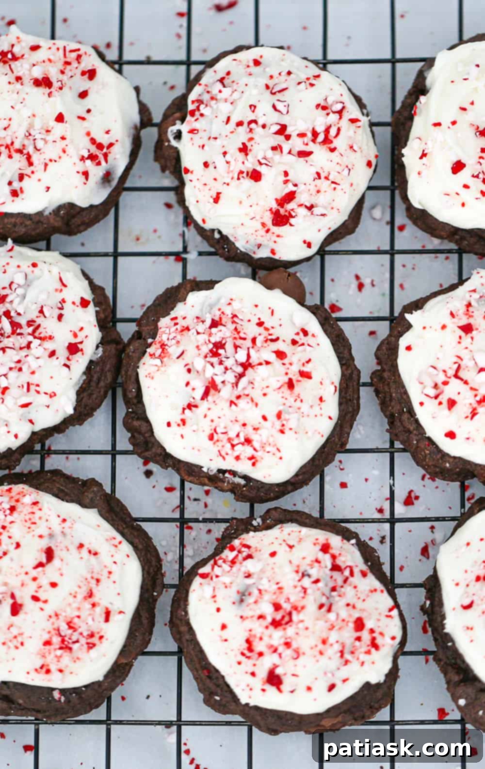 65 Festive Christmas Cookie Creations 54 Peppermint Frosted Chocolate Cookies with white peppermint frosting and crushed candy canes