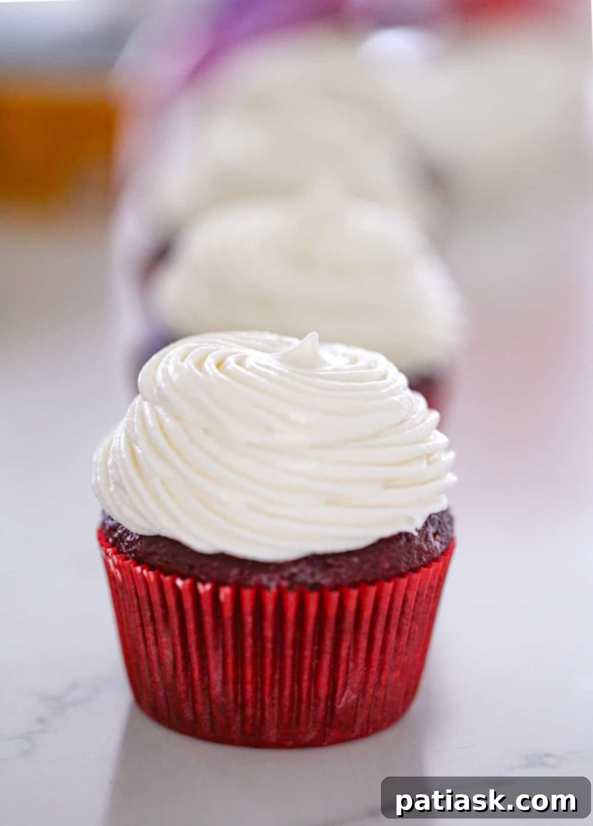 Detailed shot of cream cheese frosting in a bowl, showcasing its creamy texture