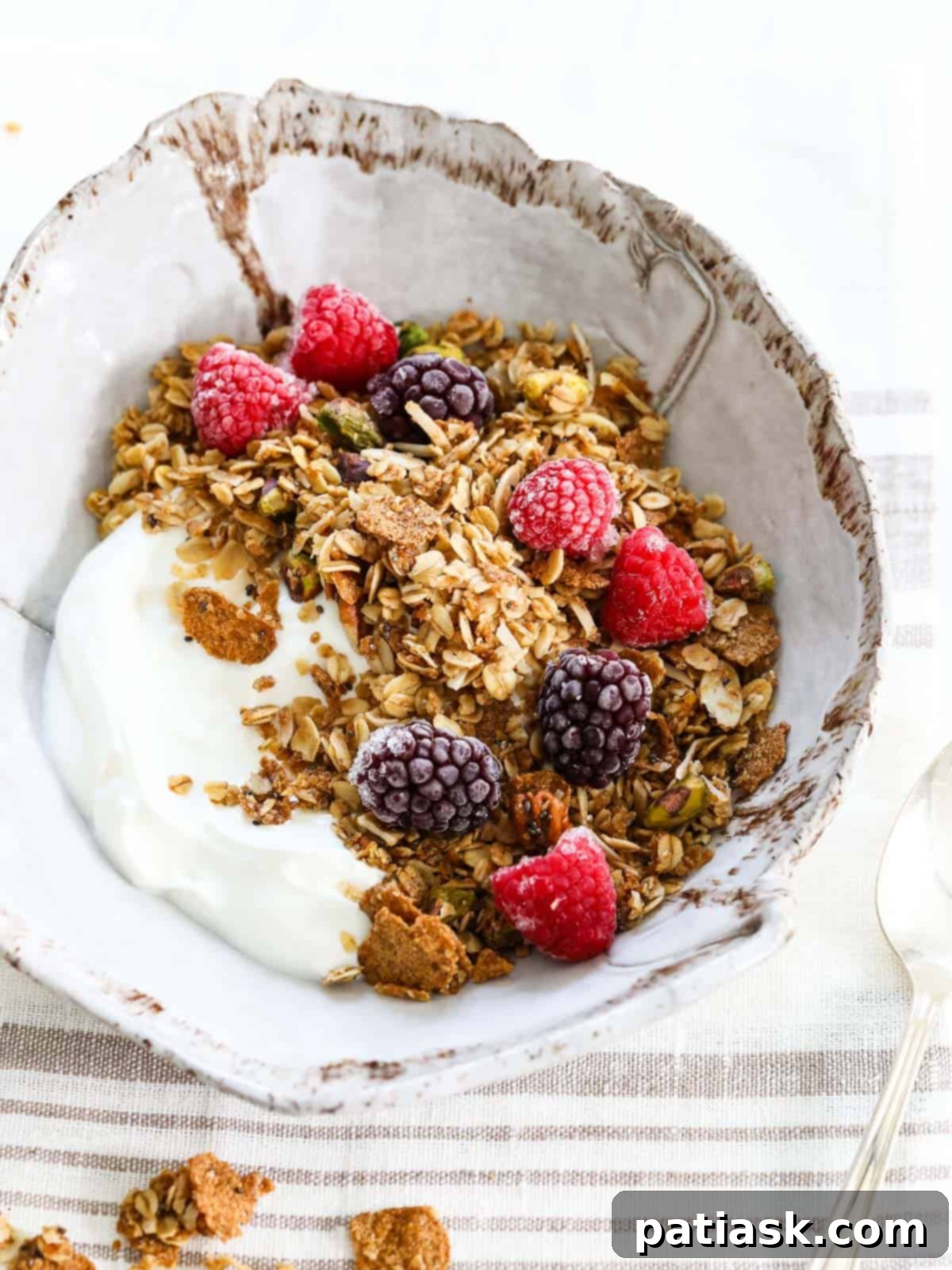 Yogurt and granola breakfast bowl with fresh fruit.