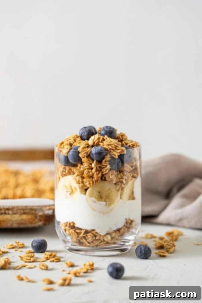 Vegan peanut butter granola with fresh berries and banana slices.