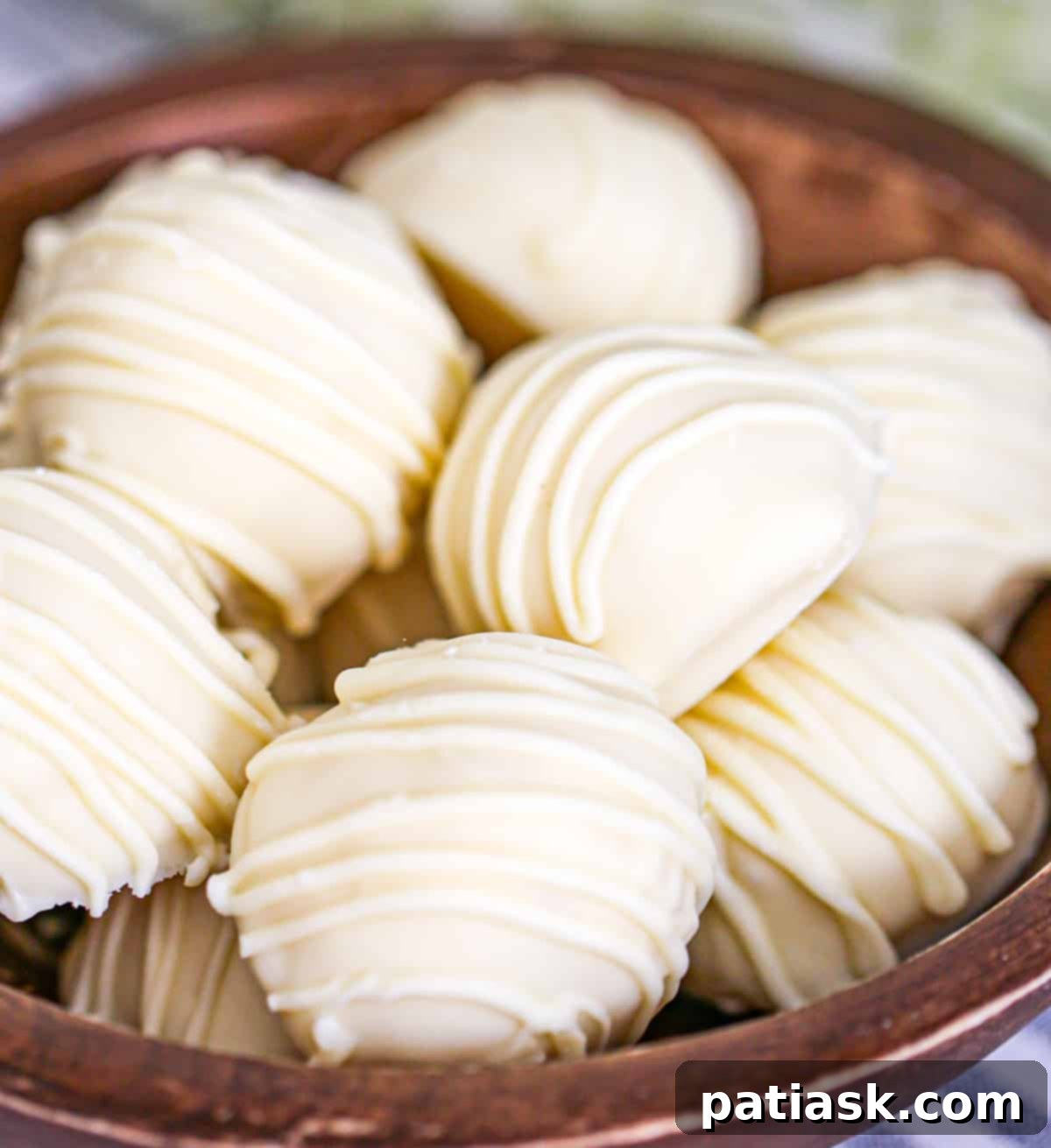 Velvet White Truffle Bliss 2 no bake truffles white chocolate recipe - a close up of perfectly round white chocolate truffles dusted with toppings