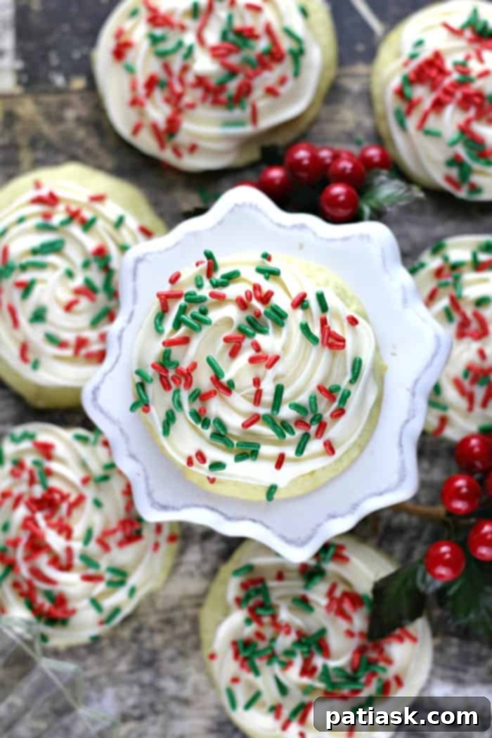 Best Soft Sour Cream Cookies with Buttercream Frosting - a close-up of fluffy, frosted sour cream cookies with festive sprinkles