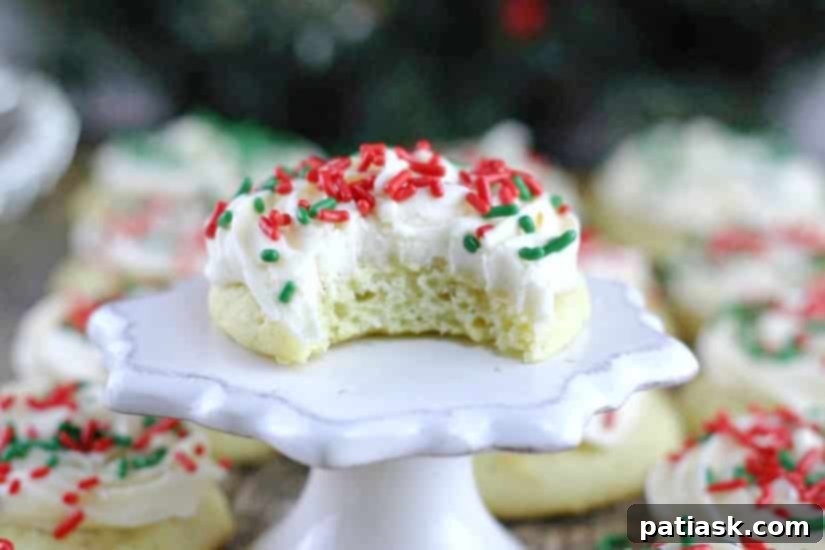 Best Soft Sour Cream Cookies recipe - a close-up of a single, frosted sour cream cookie on a white background