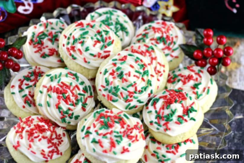 Best Soft Sour Cream Cookies with Buttercream Frosting - a decorated cookie with a bite taken out, showing the soft interior