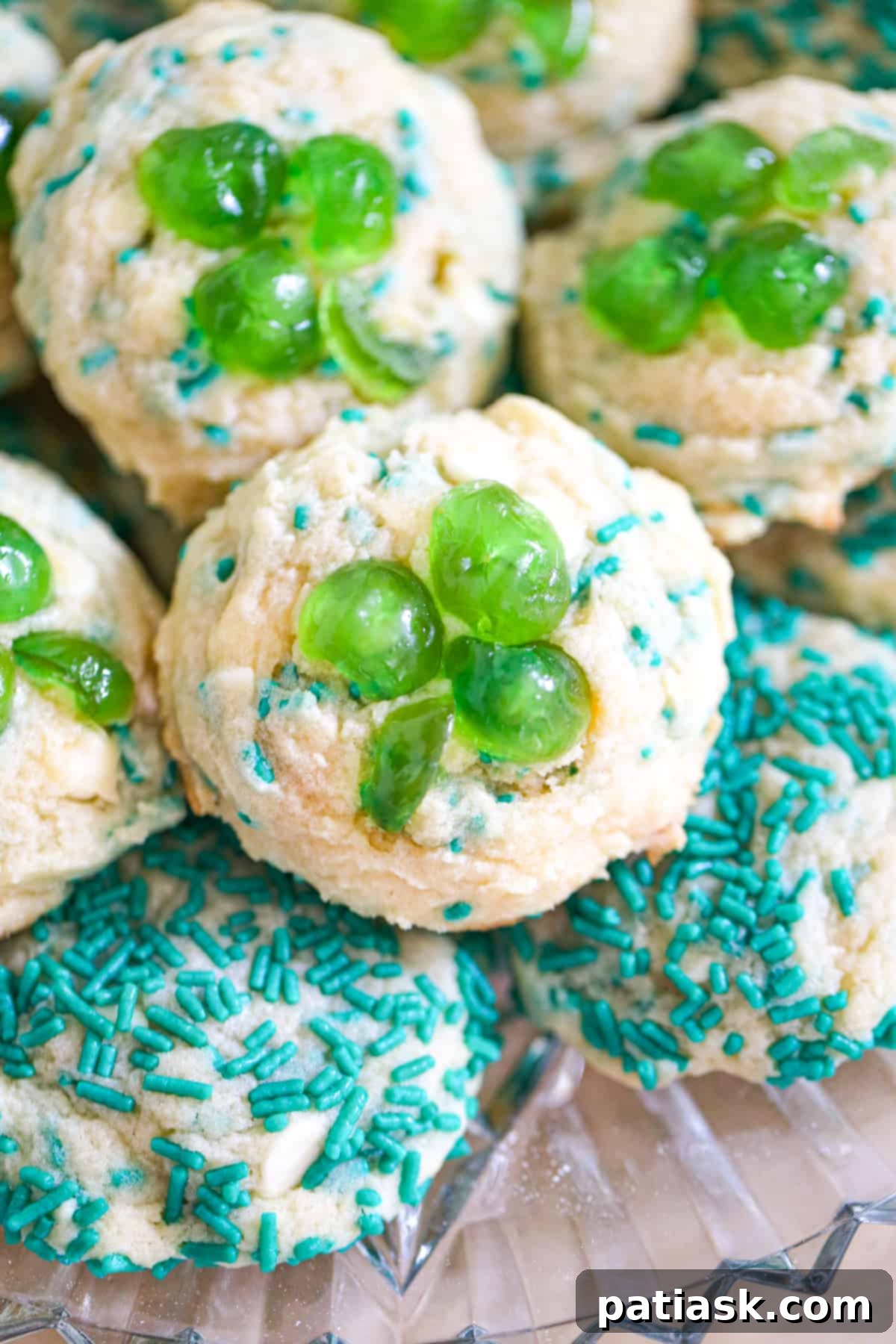 Emerald Shamrock Cherry Treats 3 St Patrick's Day Green Cherry Shamrock Cookies arranged beautifully on a festive platter, showcasing their soft texture and vibrant green color.