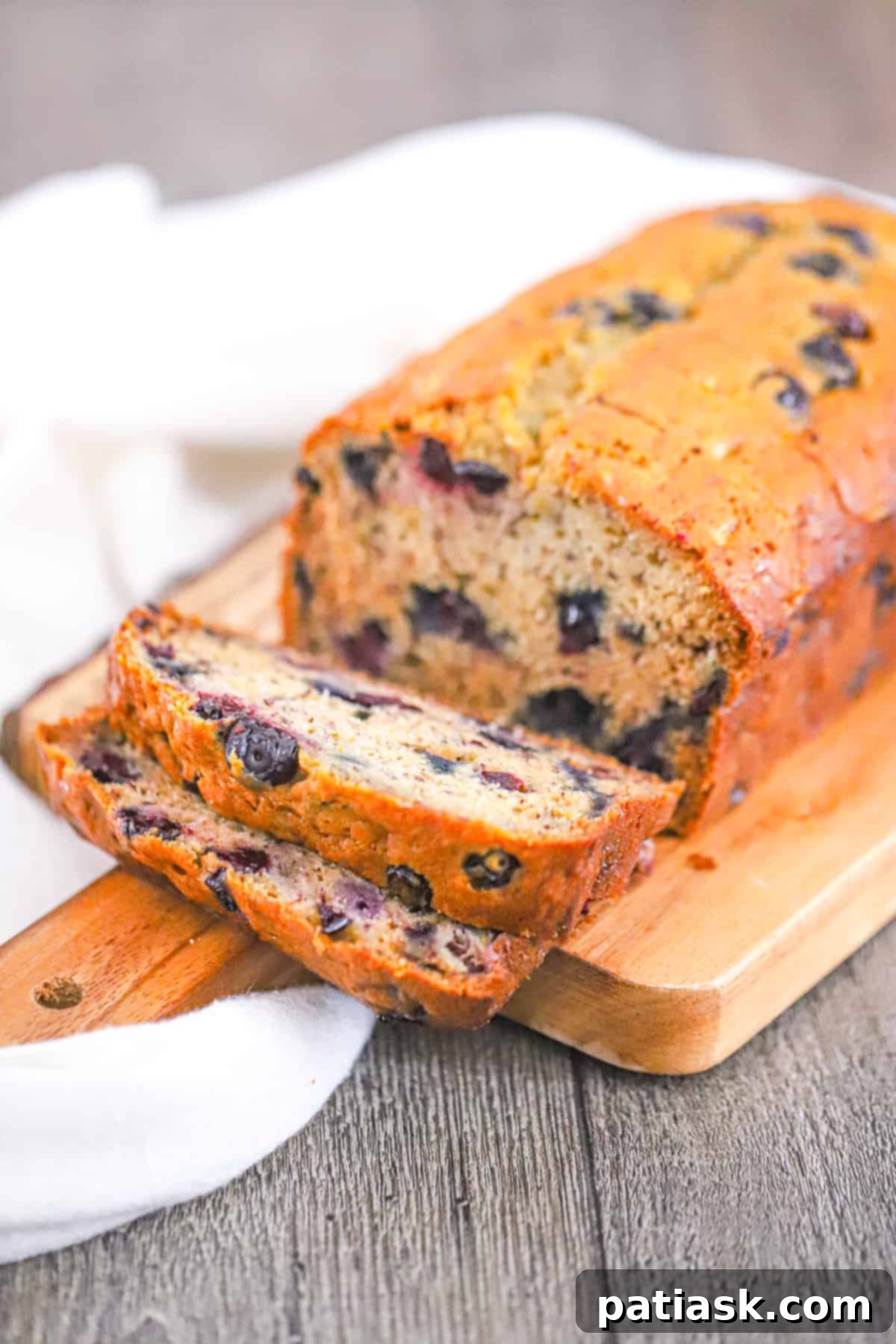 Effortless Blueberry Banana Bread 3 Close-up of moist blueberry banana bread showing the tender crumb and blueberries.
