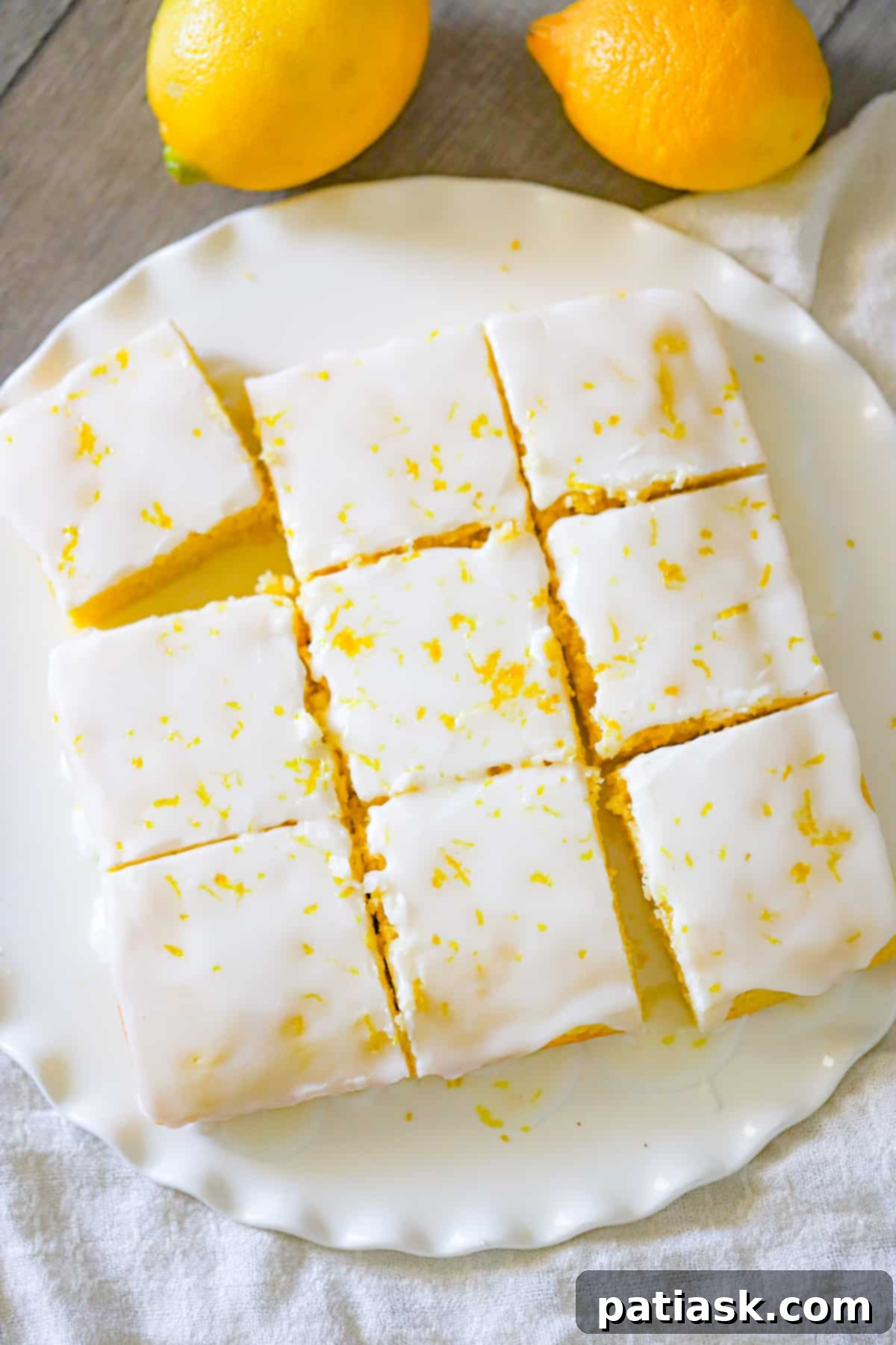 Close-up of freshly baked homemade lemon brownies on a cooling rack, showing their moist texture.