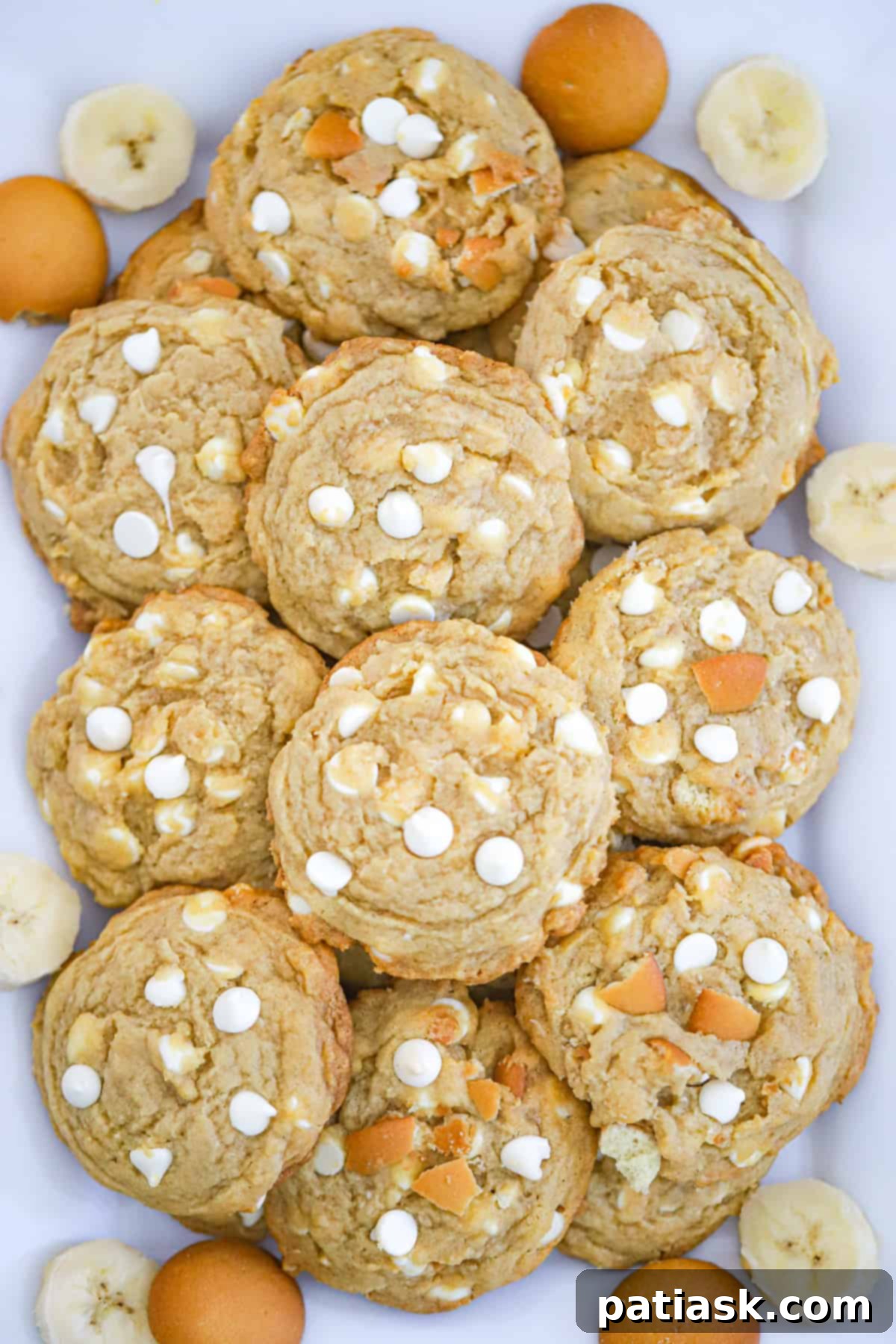 Close-up of a Banana Cream Pudding Cookie with visible white chocolate chips.