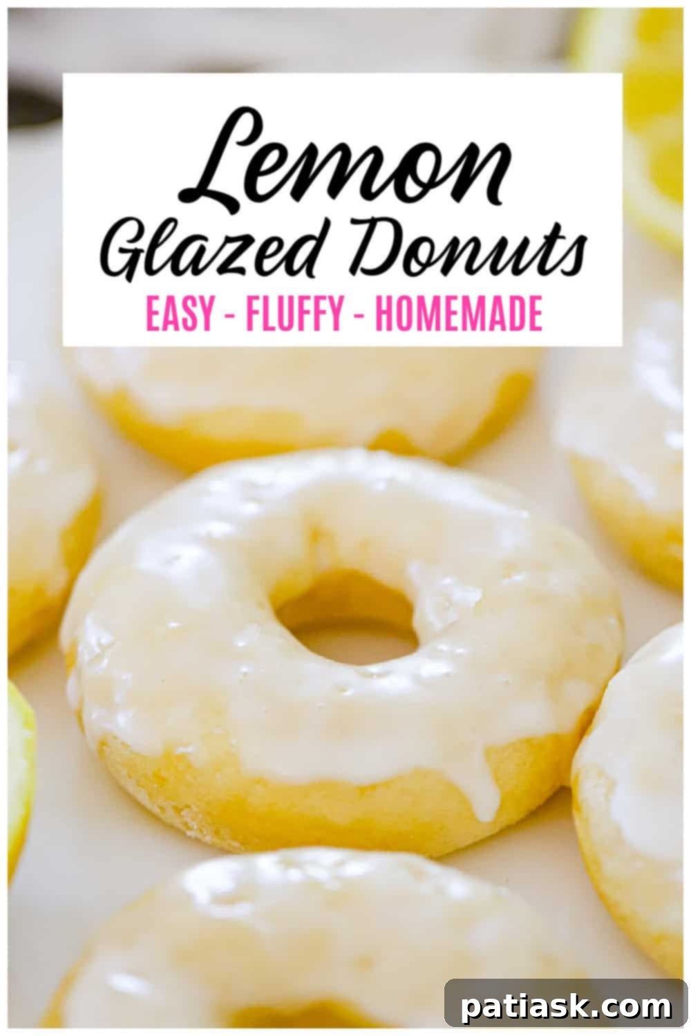 Lemon Zing Donuts 11 Overhead shot of lemon glazed donuts on a white surface with scattered lemon slices and fresh mint leaves, highlighting their freshness.