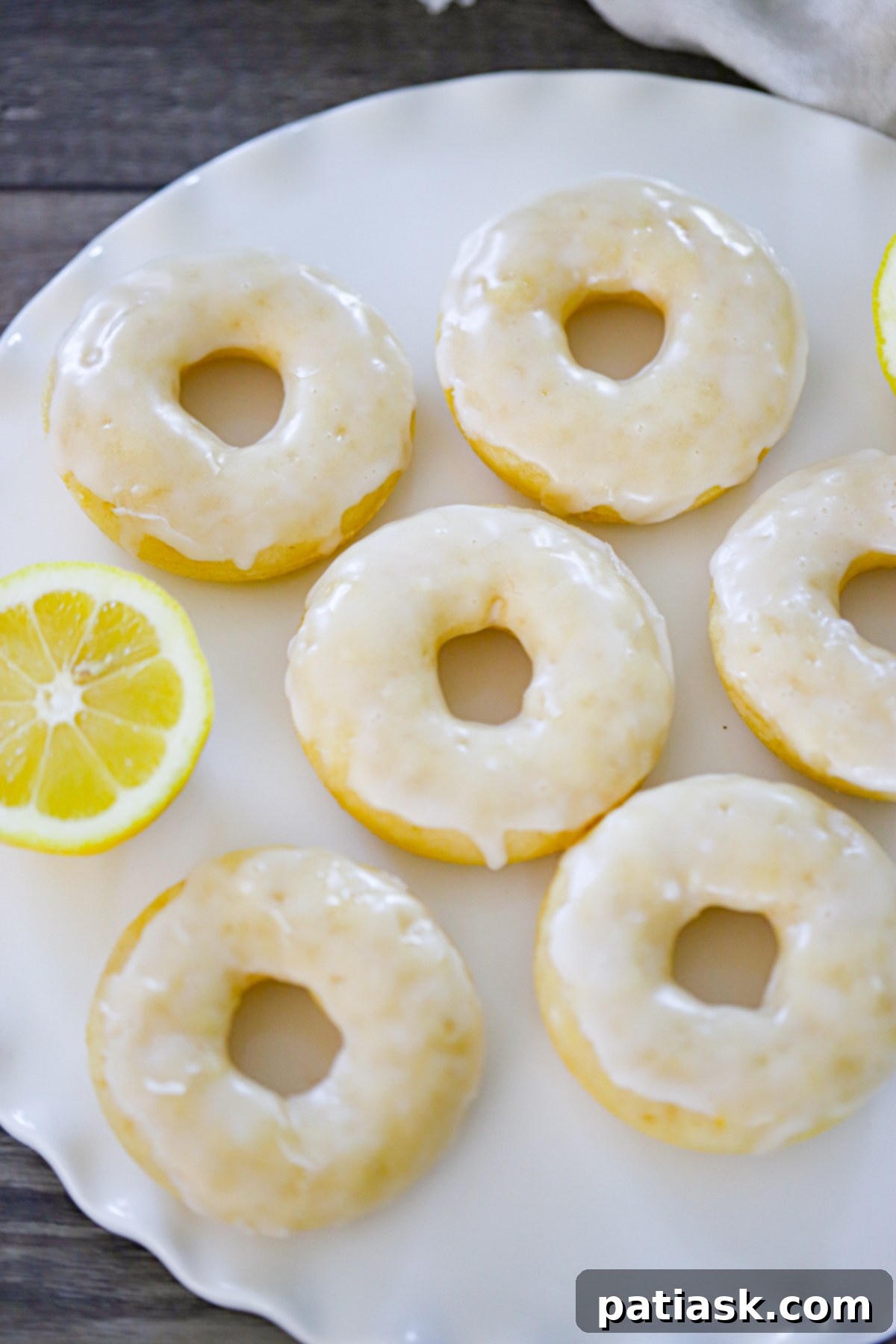 Lemon Zing Donuts 4 A close-up of baked lemon donuts, golden brown and perfectly formed in a donut pan.