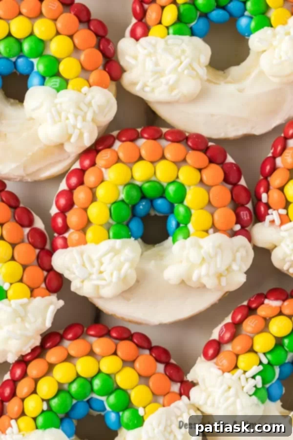 Whimsical rainbow donuts with candy rainbows and cloud frosting