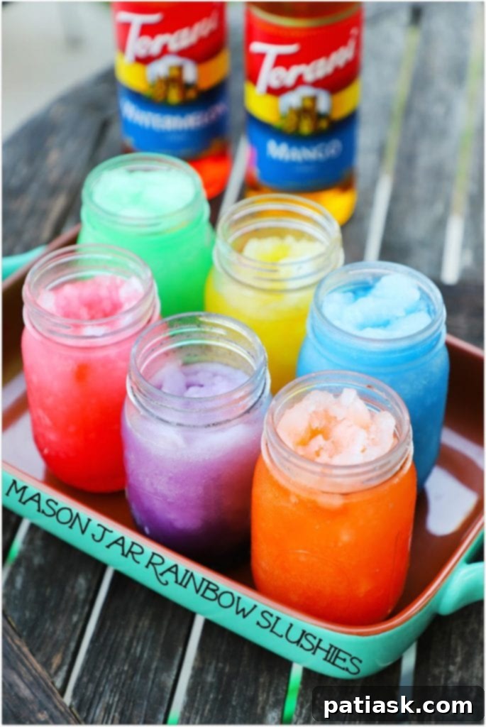 Colorful rainbow slushies in mason jars