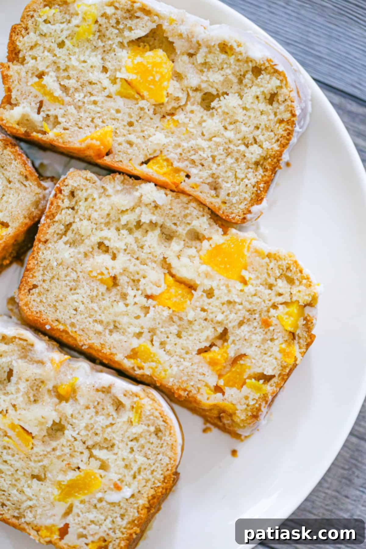 Easy Peach Cobbler Quick Bread 8 Slices of the easiest peach cobbler bread, showcasing its perfect glaze and inviting texture, a delightful homemade peach dessert.