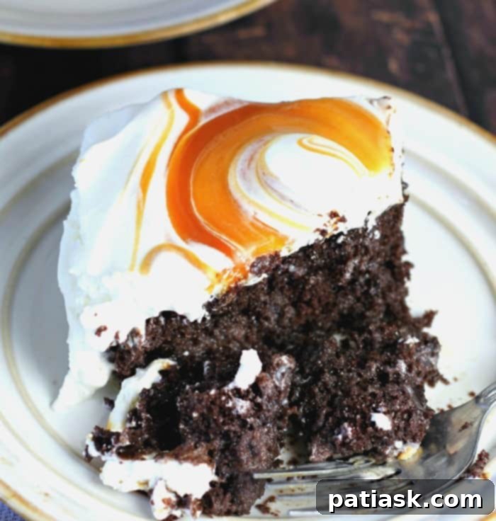 Sweet & Simple: 40 Easy Caramel Dessert Ideas 18 Caramel Cream Chocolate Poke Cake slice with whipped cream