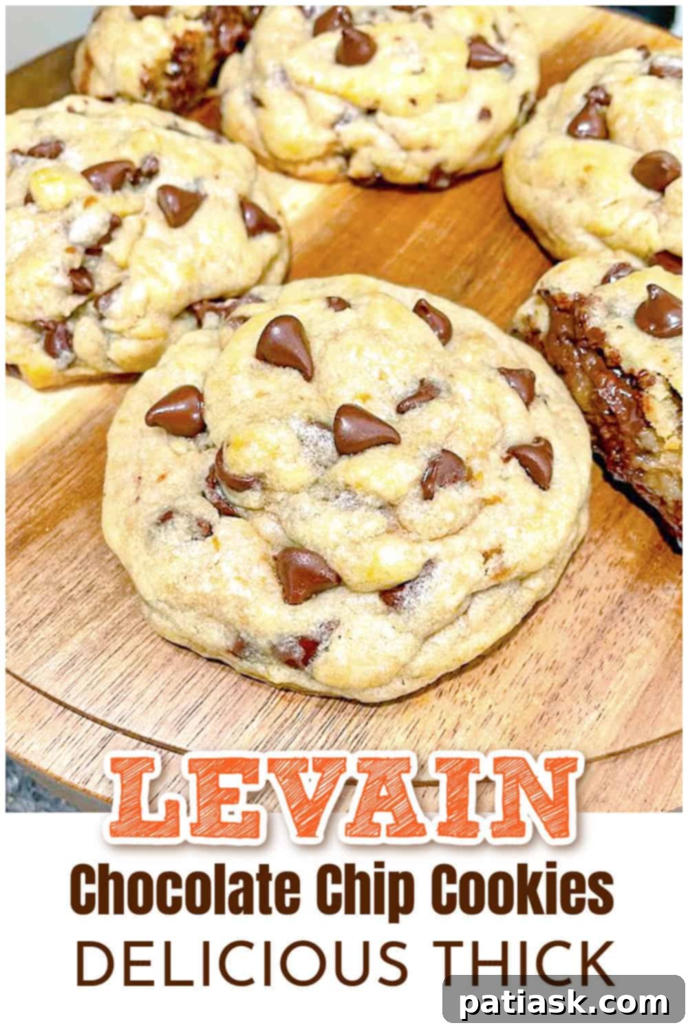 Three Ultimate Chocolate Chip Levain Cookies on a cooling rack