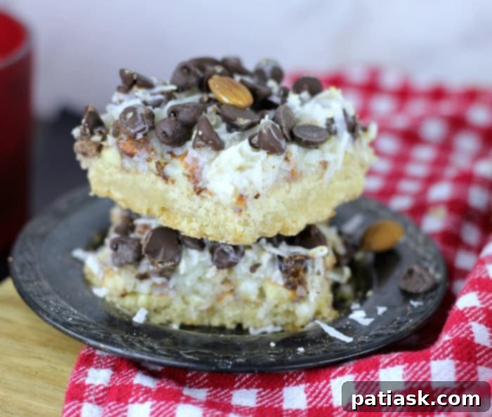 Almond Coconut Dream Bars 2 Ultimate Almond Joy Magic Bars - a close-up showing the layers of crust, coconut, almonds, and chocolate chips