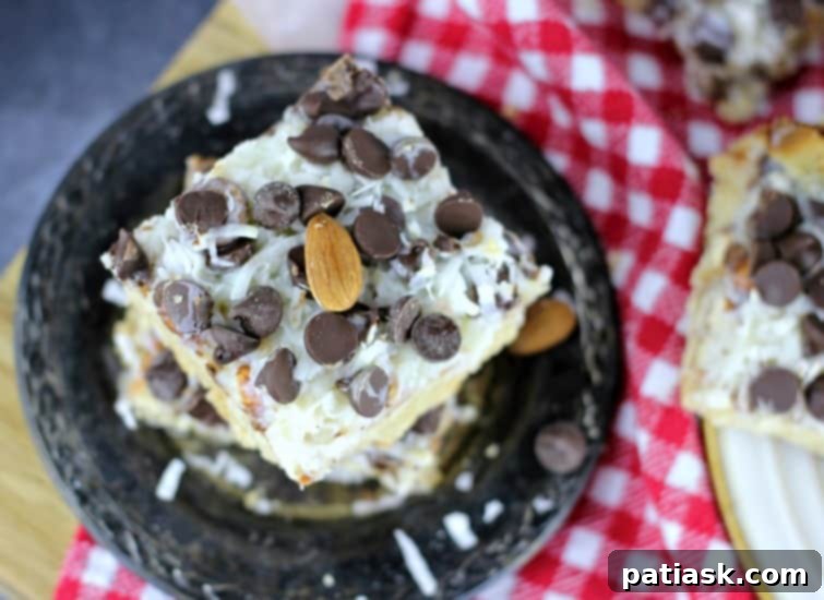 Almond Coconut Dream Bars 5 A tray of freshly baked Ultimate Almond Joy Magic Bars, showcasing the golden crust and melted chocolate