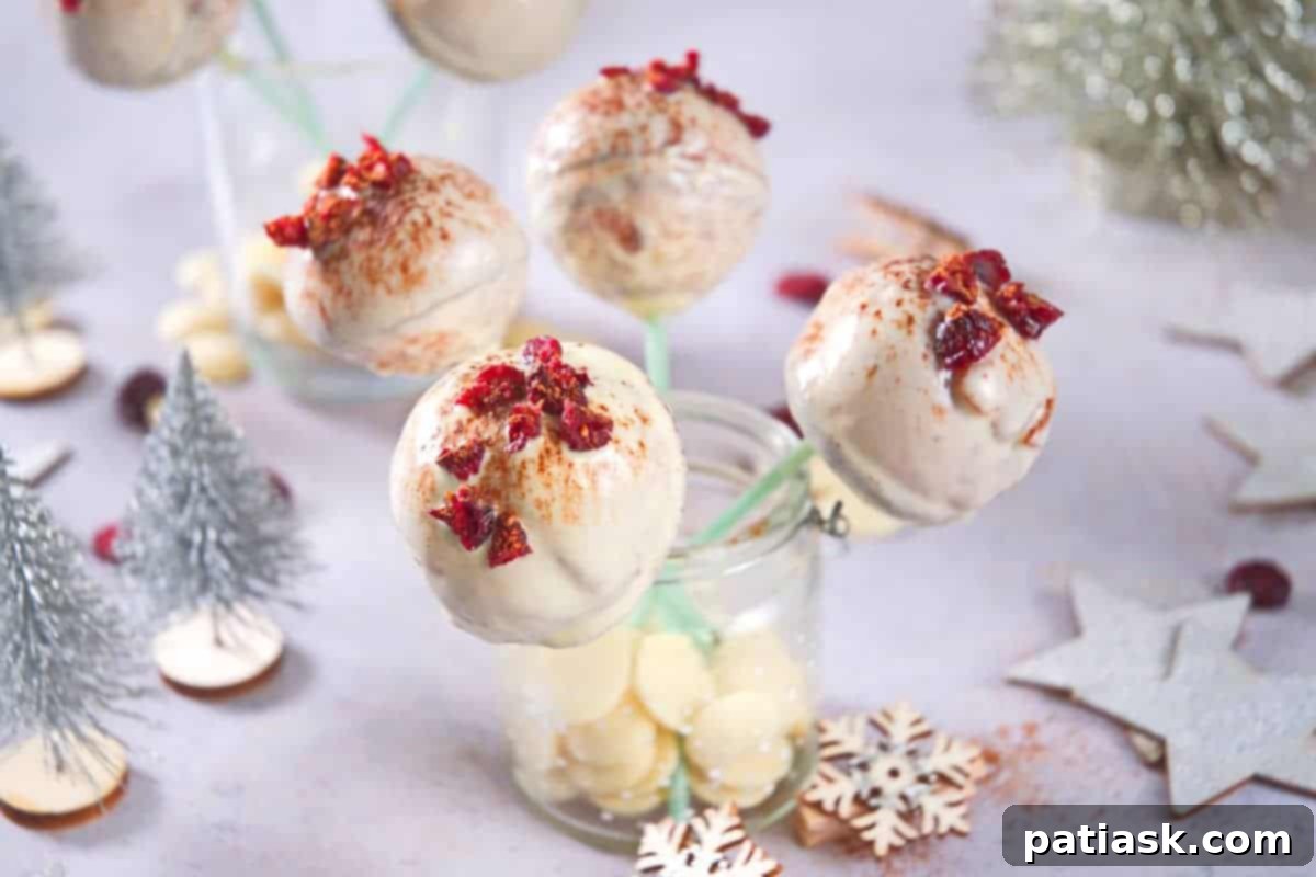 A collection of cranberry white chocolate cake pops, decorated and arranged artfully.