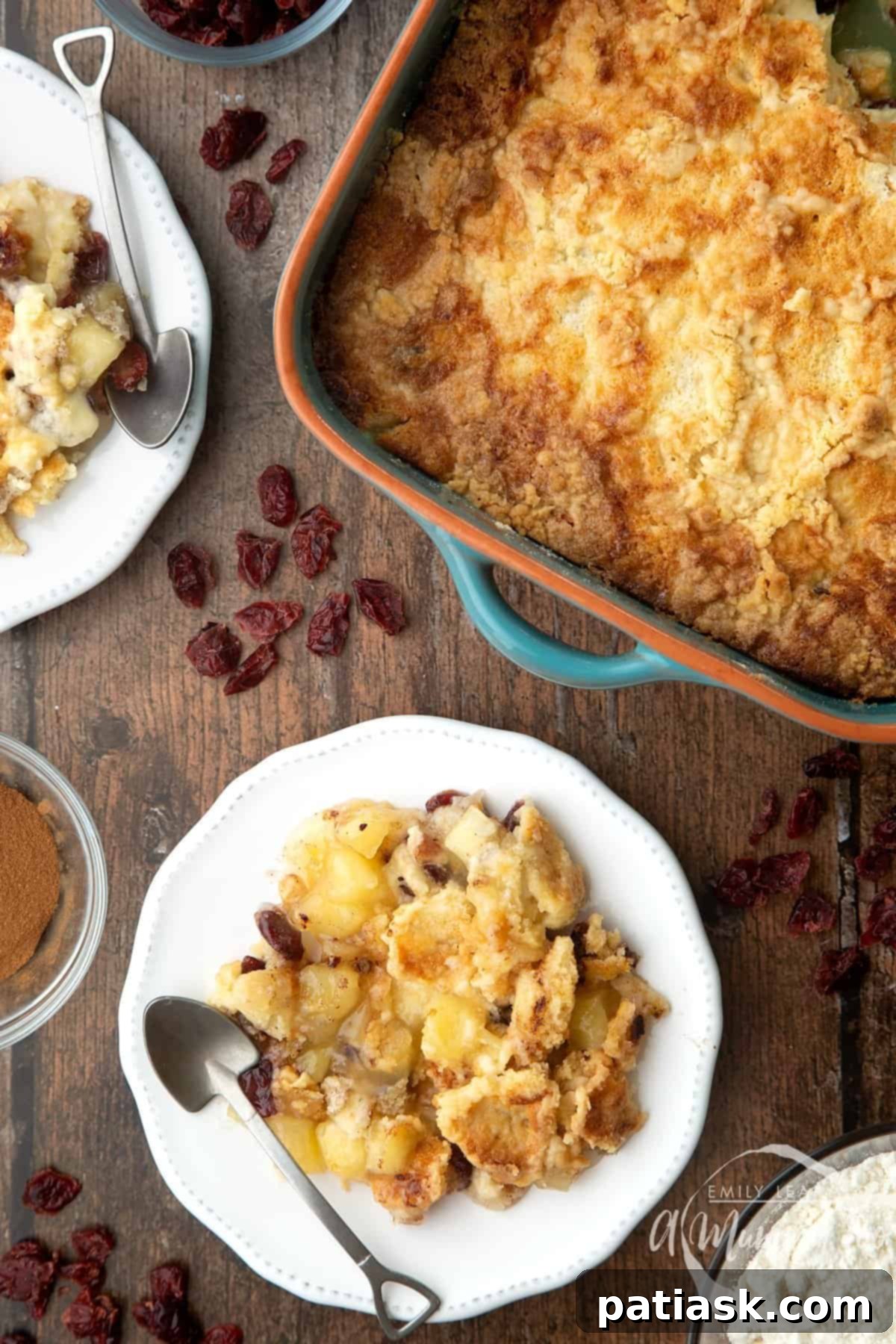A rustic apple cranberry dump cake in a baking dish, showing its golden crumb topping and fruit filling.