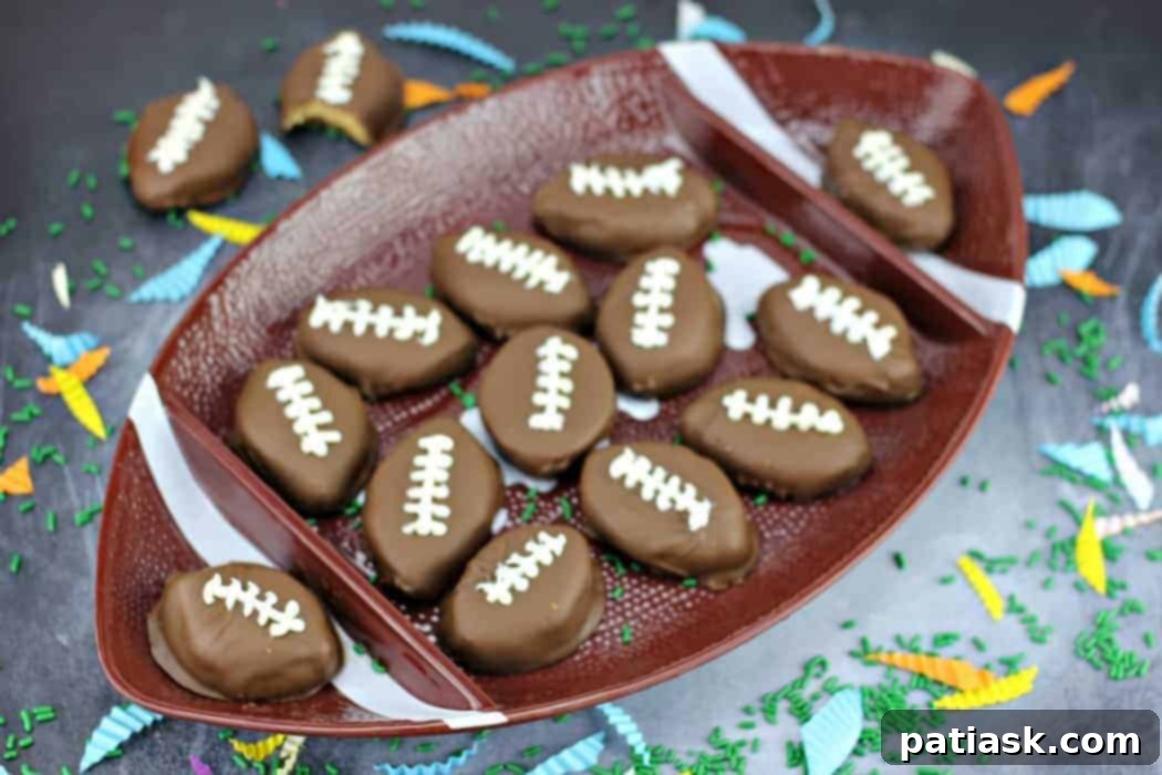 Touchdown Chocolate Peanut Butter Delights 3 Close-up of freshly made Homemade Chocolate Peanut Butter Cup Footballs, showcasing the rich chocolate coating and detailed white icing laces.