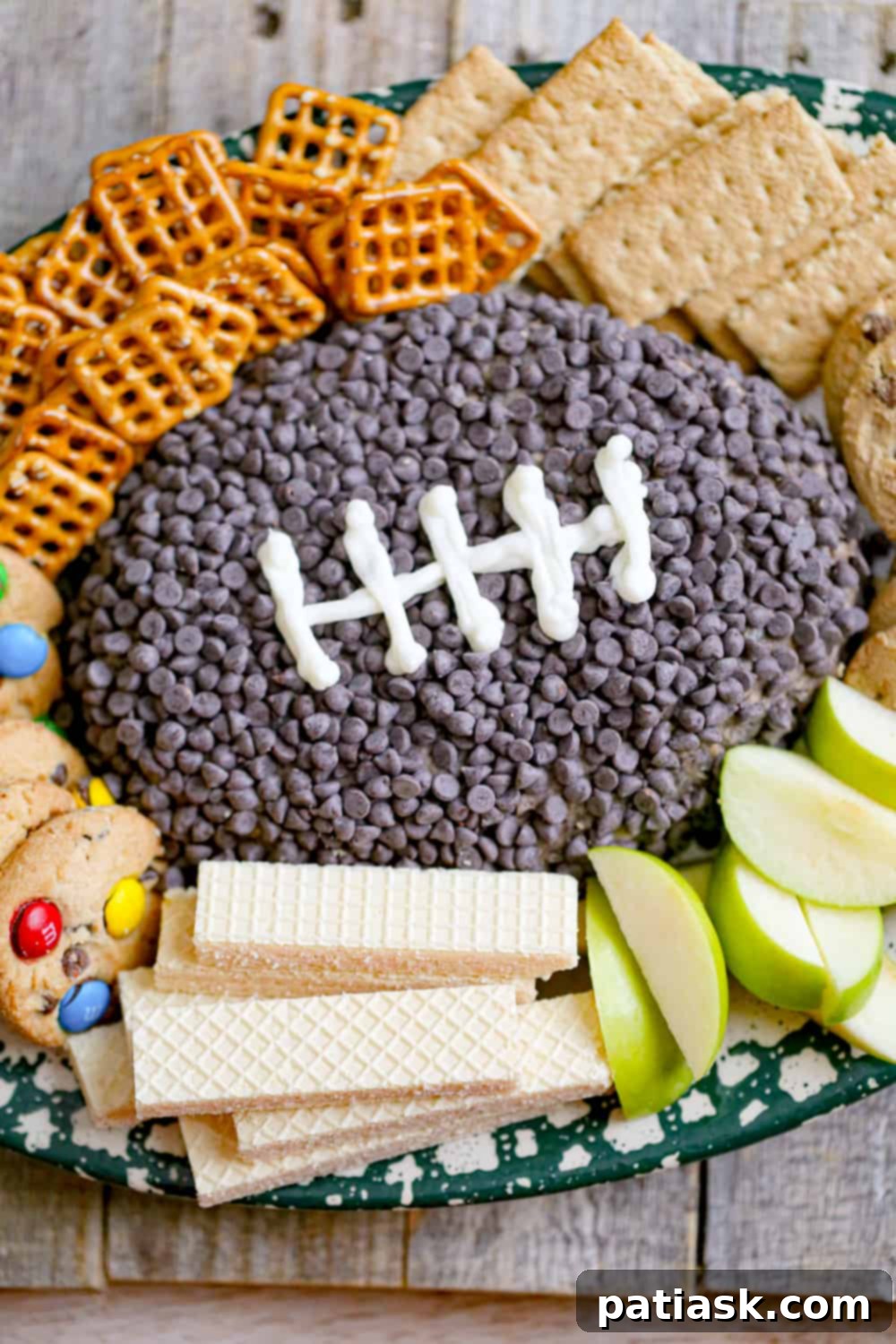 Oreos Cookies & Cream Football Dip, a creamy, football-shaped cheese ball loaded with Oreo bits, perfect for game day snacks.